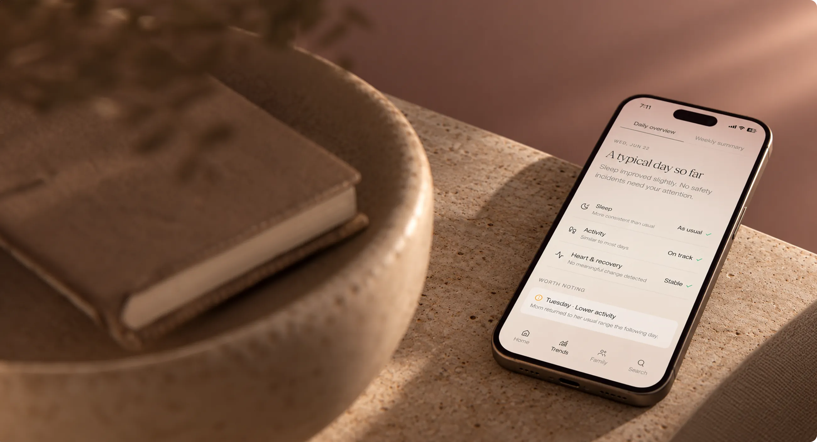 The Nona app open on a phone, resting on a book